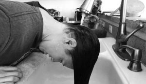 wash head and hair in a sink